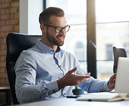 mirthful-employee-looking-at-the-laptop-screen-and-2021-10-26-01-44-20-utc-1